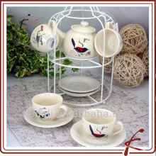 Juego de té de cerámica con diseño de pájaro y stander de hierro